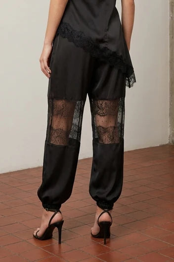 Back view of black Satin Balloon Pants with Lace showing lace panels and gathered cuffs